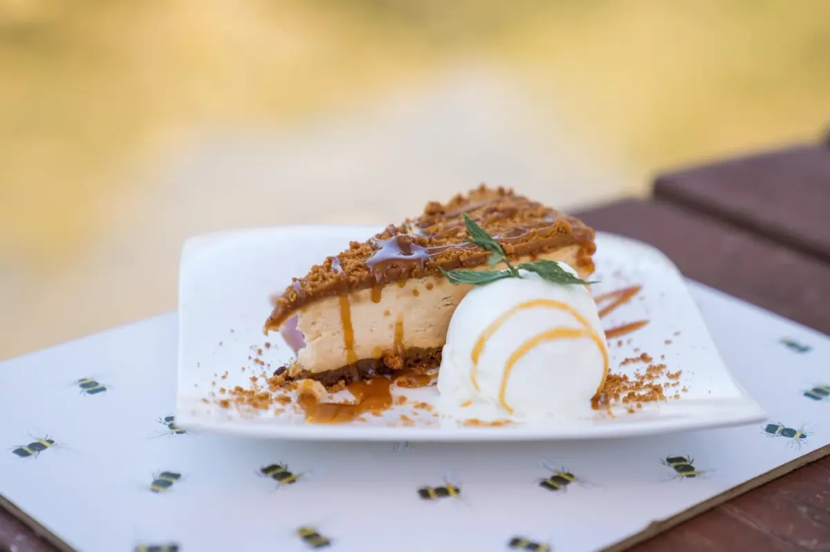 A caramel-topped dessert with a scoop of ice cream, served in the garden