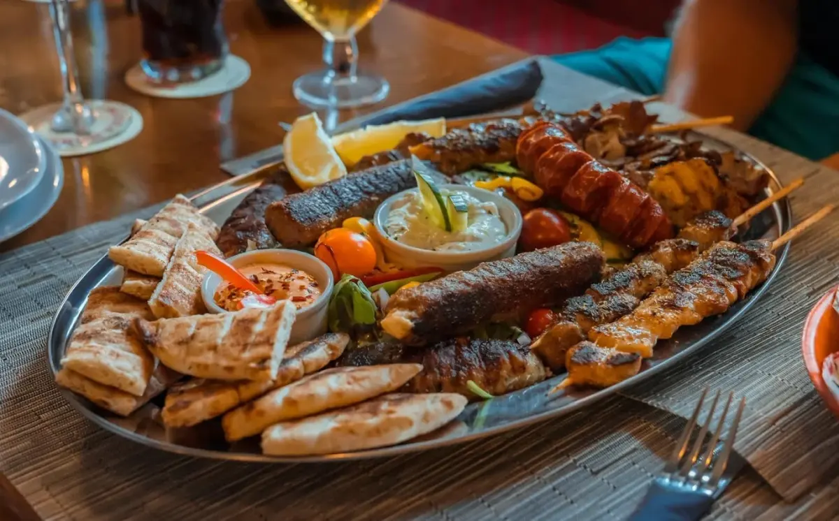 A mixed grill platter of skewers, gyros, koftas, pitta bread and dips
